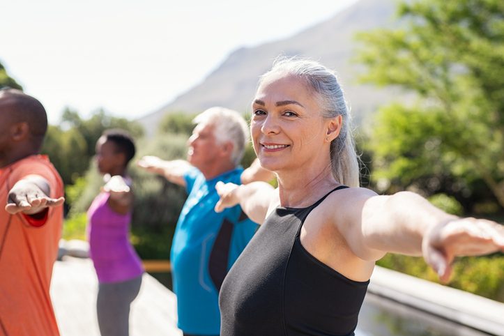 A Group of People Doing Pilates Outdoors