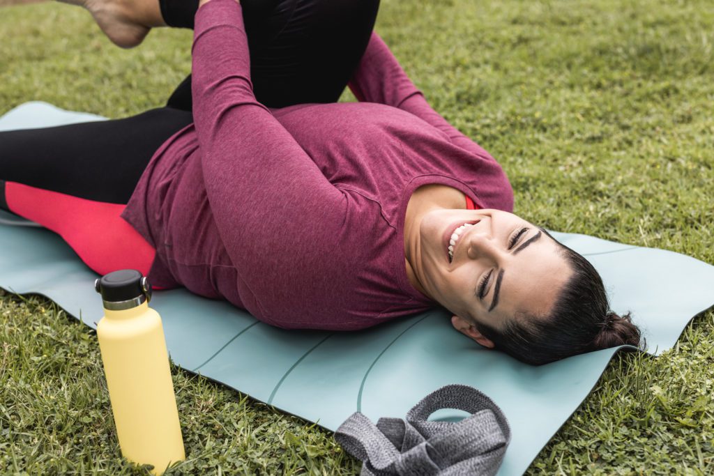 Woman Smiling While Doing Pilates